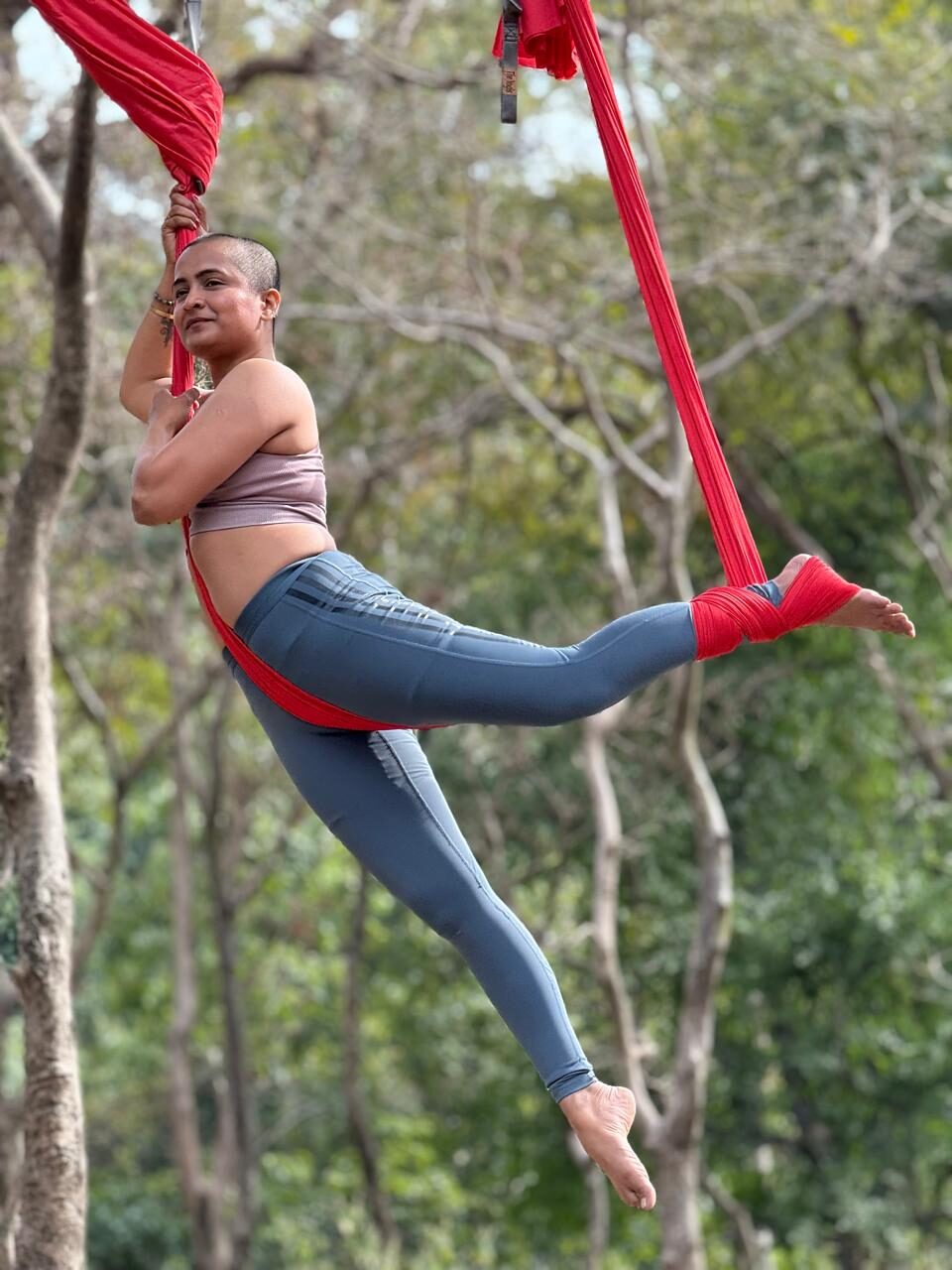 Mayuri Shewale demonstrating aerial yoga technique.
