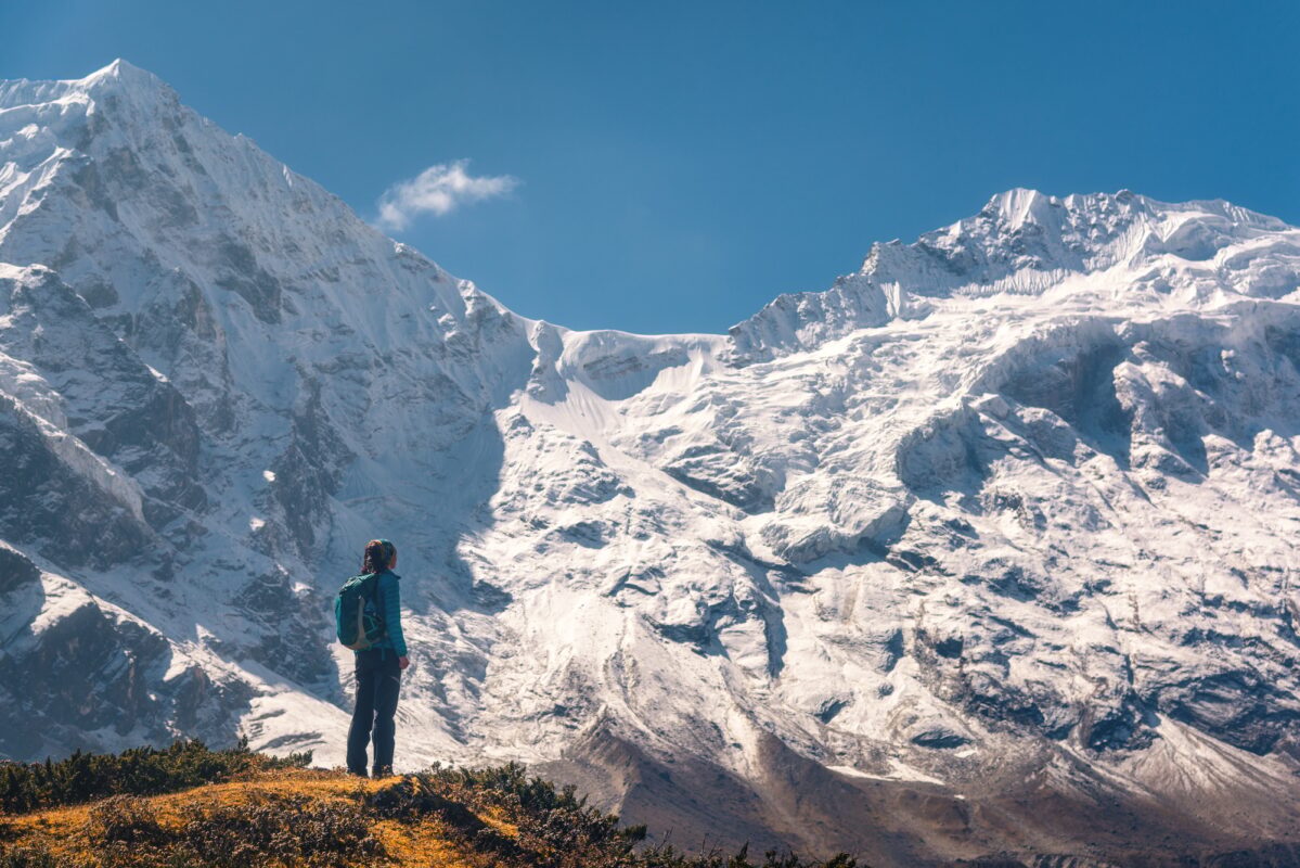 Yoga student overlooking Himalayan mountains in Rishikesh, India.